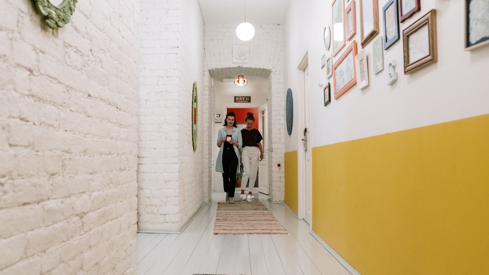 Patterned runner rug laid across a wooden hallway floor with natural light
