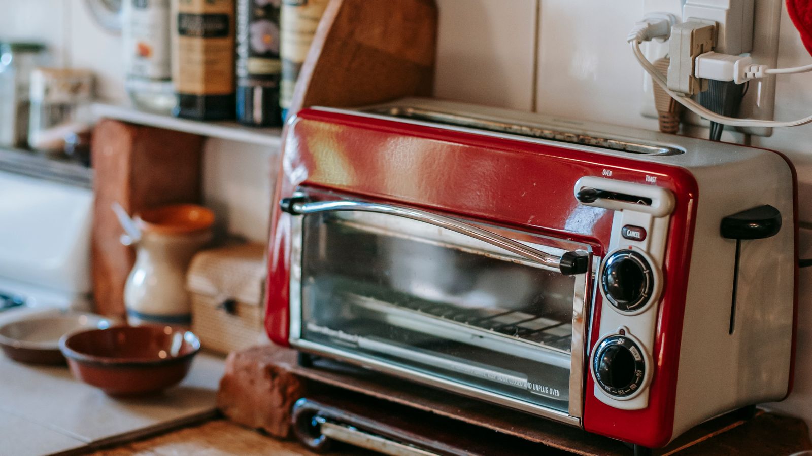 Roll of paper towels sitting on a kitchen counter next to a toaster oven