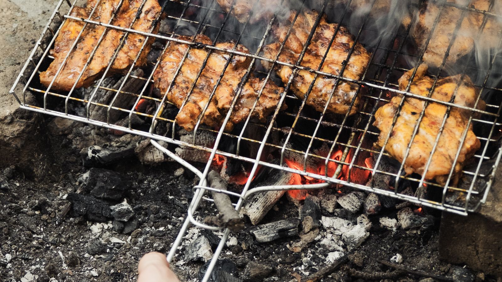 Outdoor grill setup used for rotisserie cooking on a patio