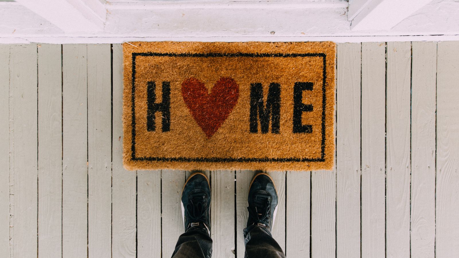 A woven runner mat laid across a narrow kitchen floor space