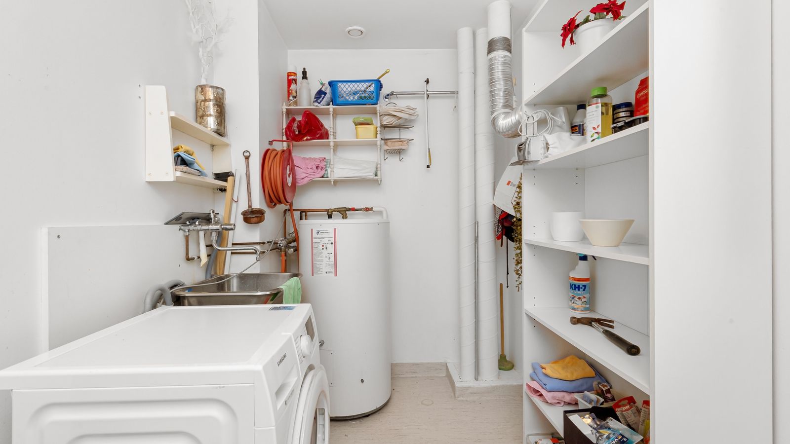 Laundry room with washer and dryer sitting on pedestal drawers
