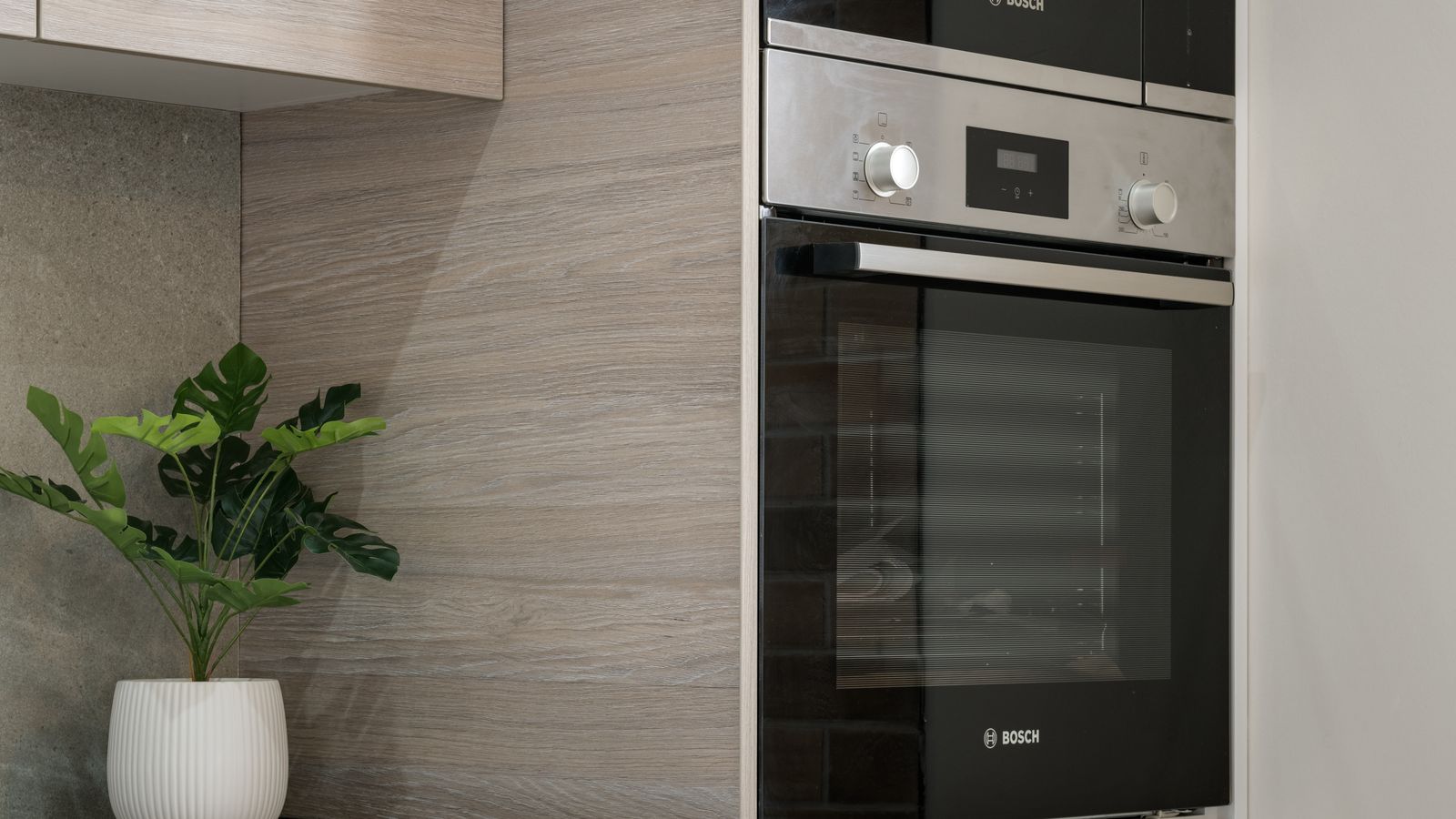 Modern kitchen renovation with new built-in appliances and cabinetry under construction
