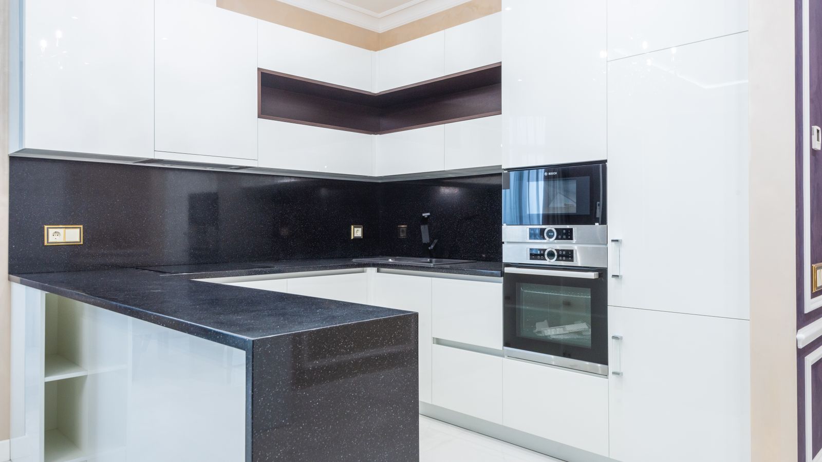 Homeowner comparing quartz countertop sample chips on a kitchen island during a renovation planning session