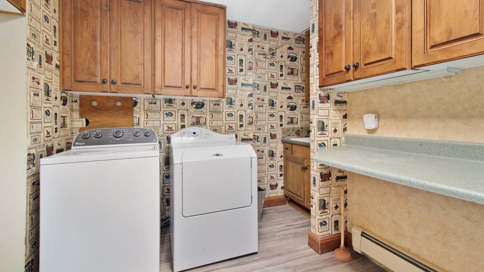Small laundry room with folded towels and organized storage baskets