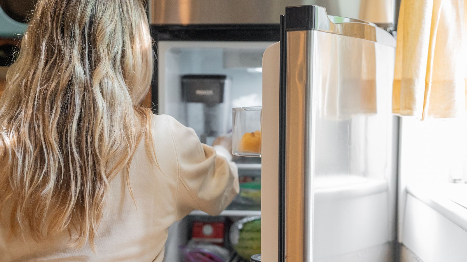 Stainless steel refrigerator and kitchen appliances during a home renovation budget planning session