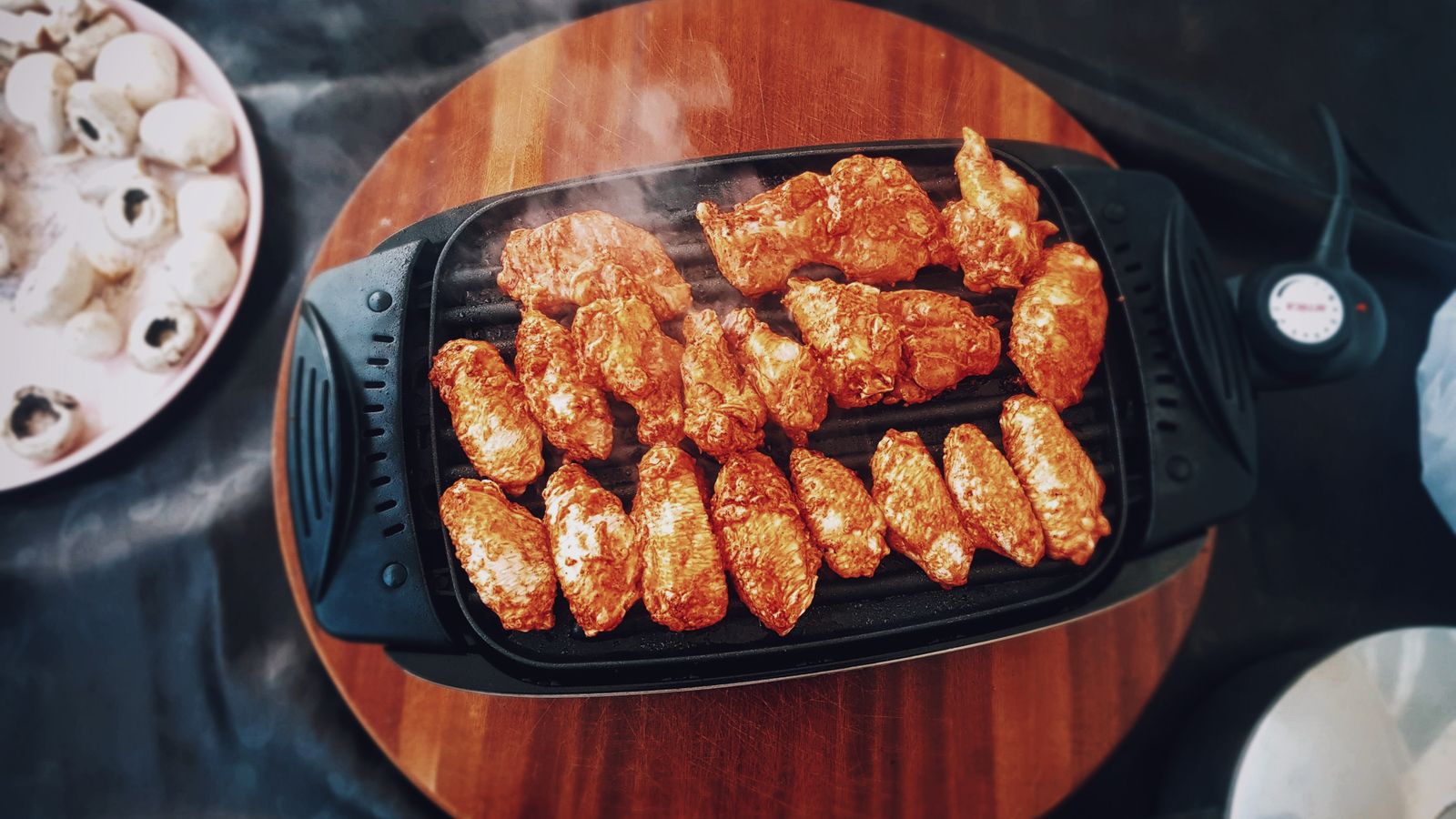 Close up of meat being grilled on an electric countertop grill plate