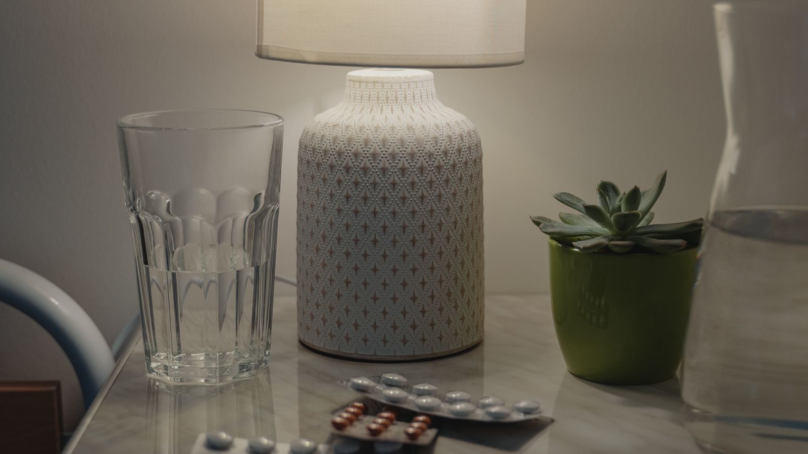 Table lamp with dimmer switch glowing softly on a nightstand