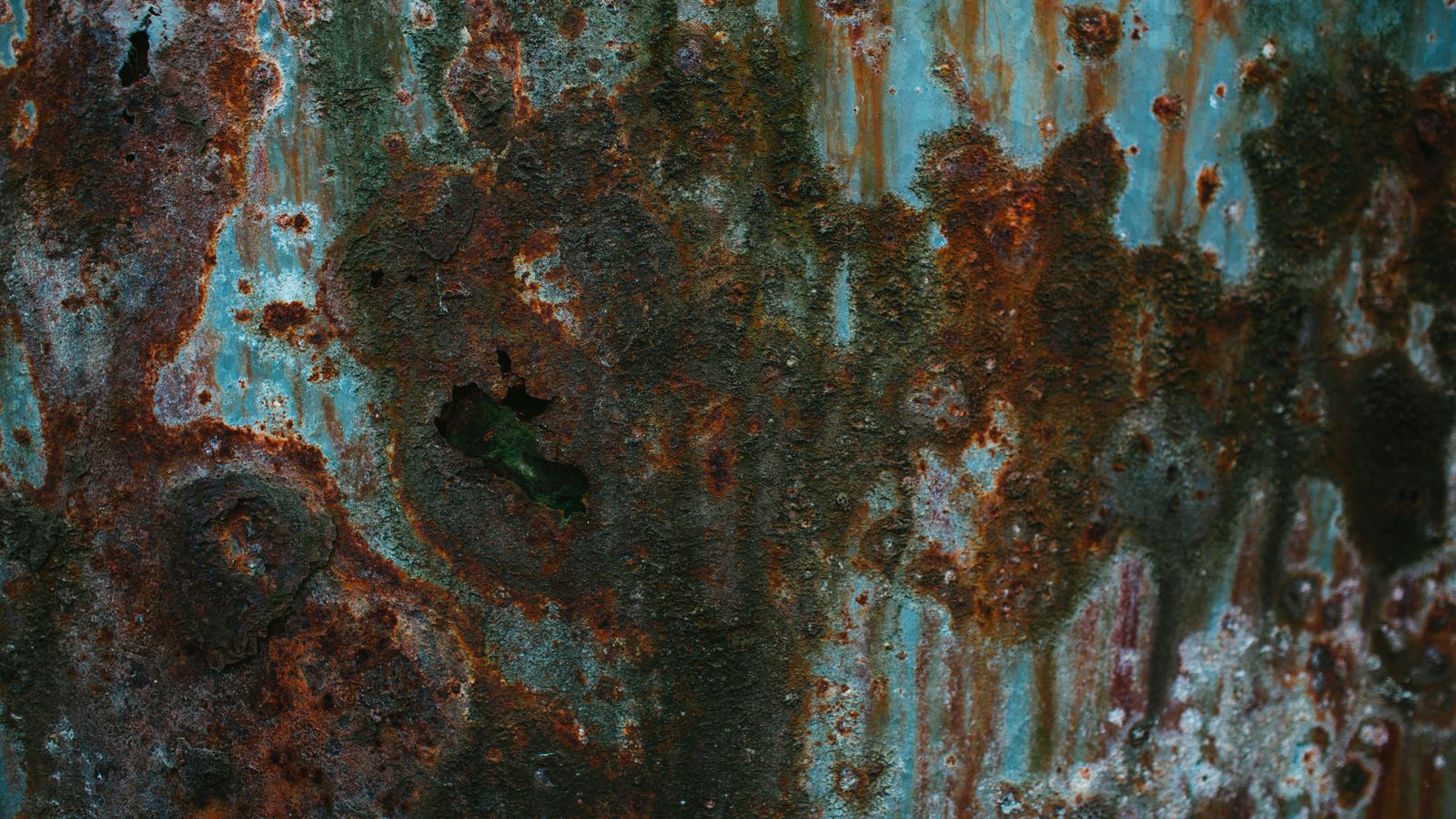 Rusted metal tool being treated with a rust remover solution on a workbench