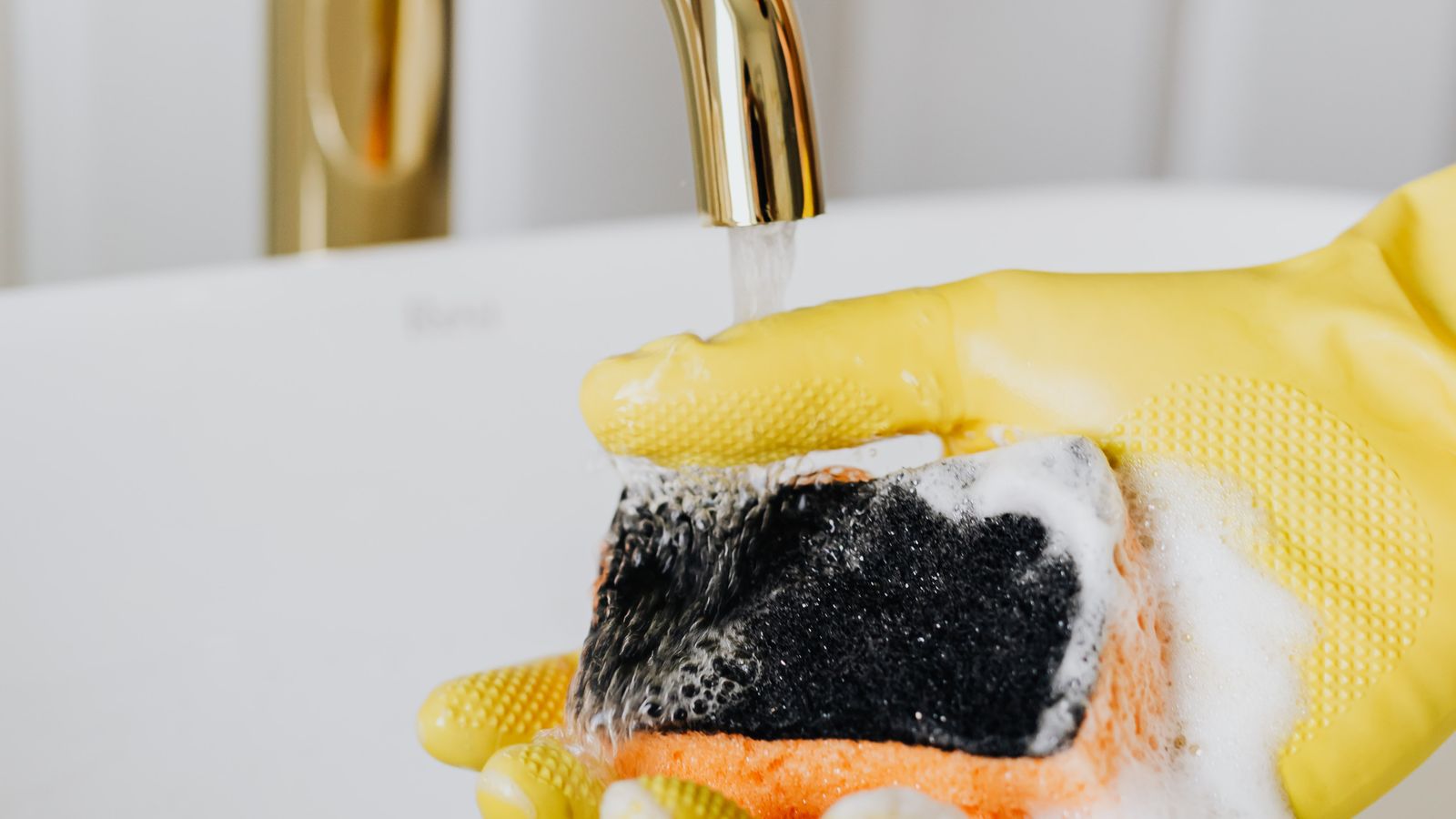 Close-up of vinegar and baking soda fizzing inside a small bar sink basin