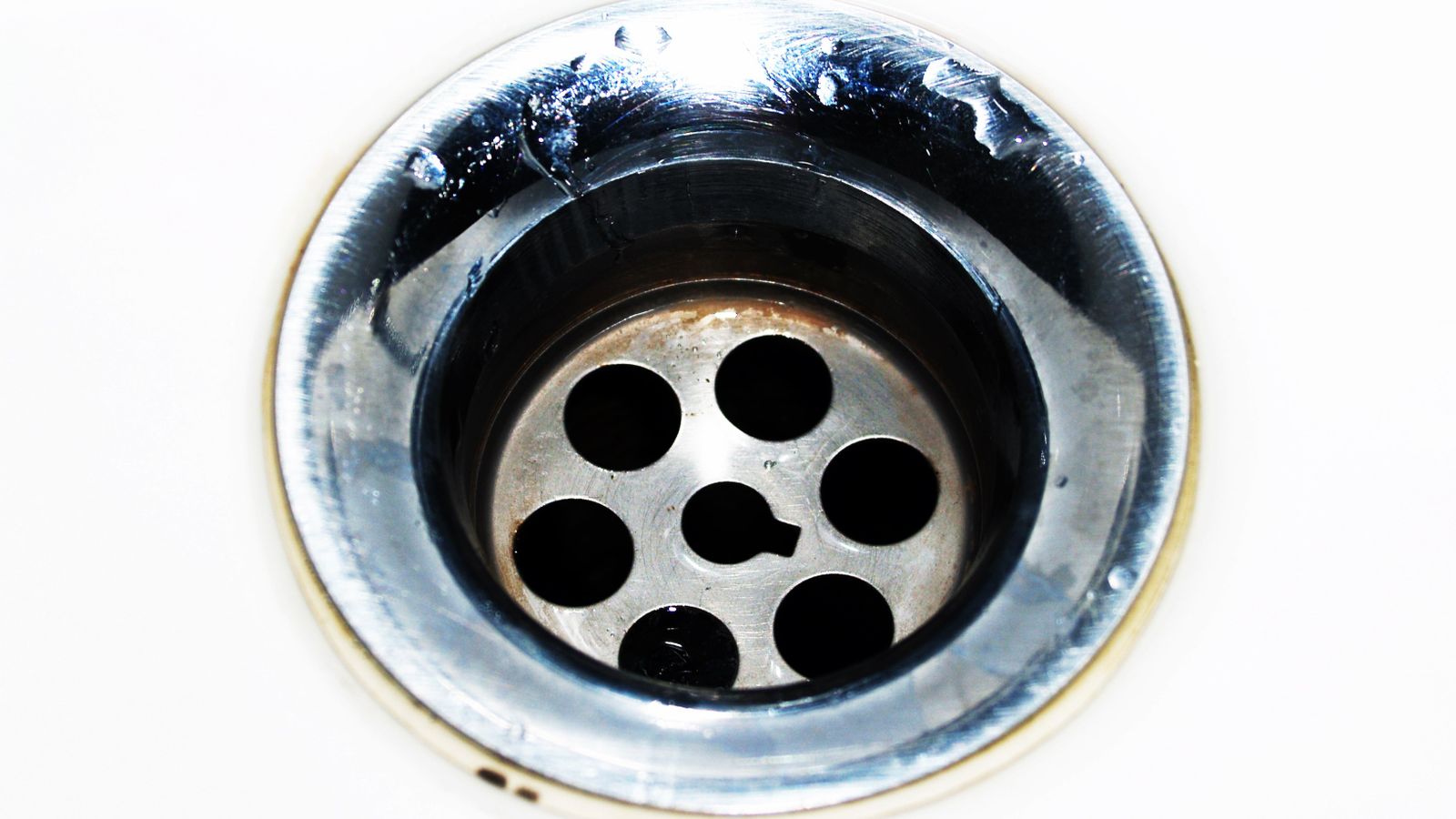 Stainless steel kitchen sink with garbage disposal drain ready for cleaning