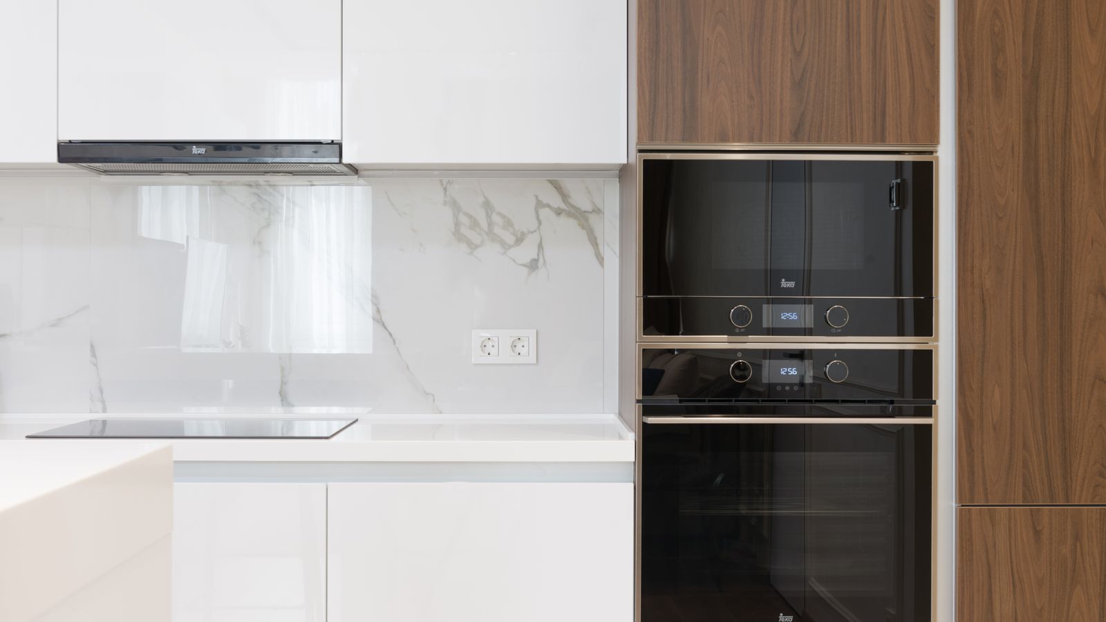 Clean modern kitchen with a built-in slide mount range and surrounding cabinetry