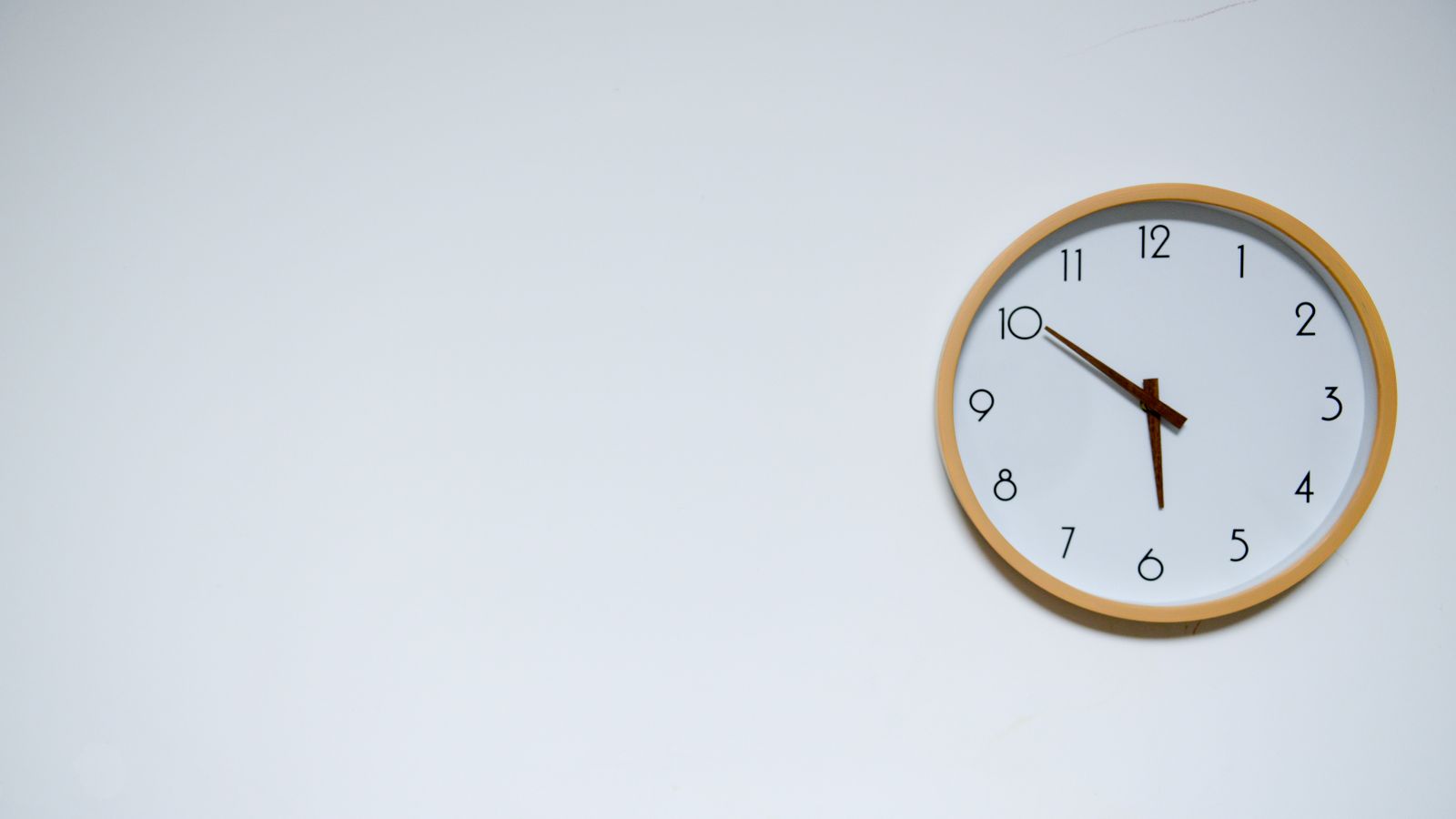 Close-up of a dusty wall clock face before deep cleaning