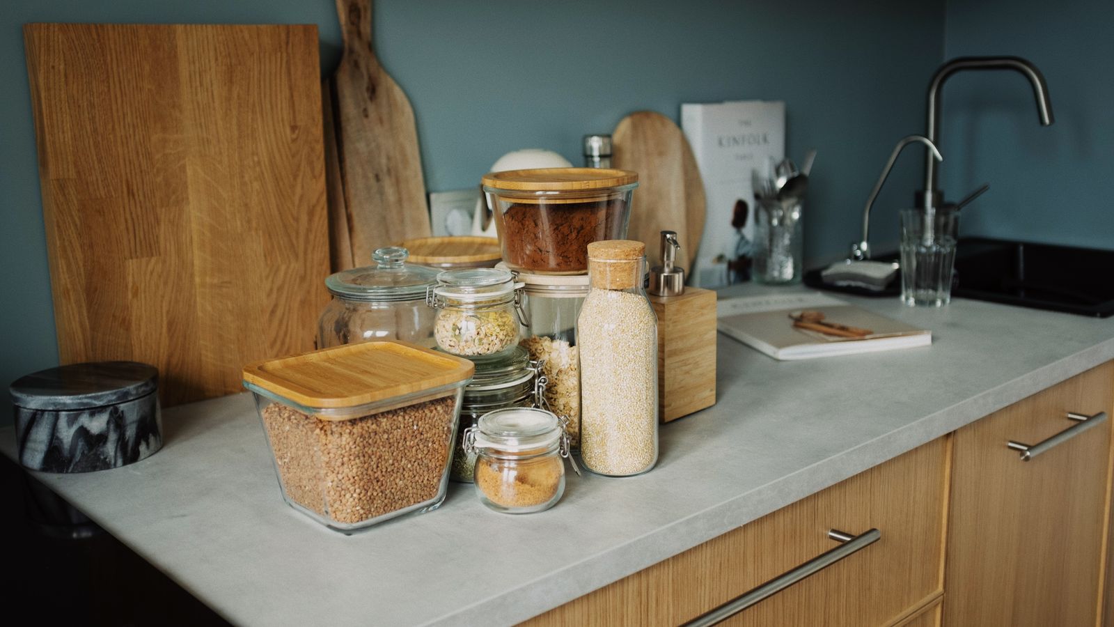 Glass jars and kitchen tools organized on a small section of countertop