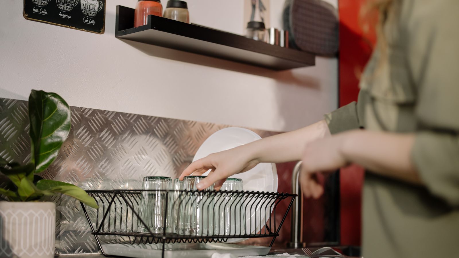 Organized kitchen counter with jars, utensil holder, and cutting board arranged neatly