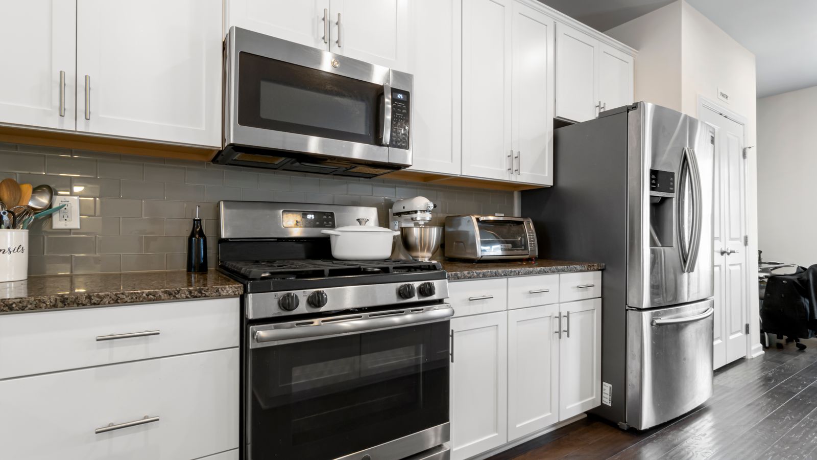 Built-in wall oven and speed oven combo installed in renovated kitchen cabinetry