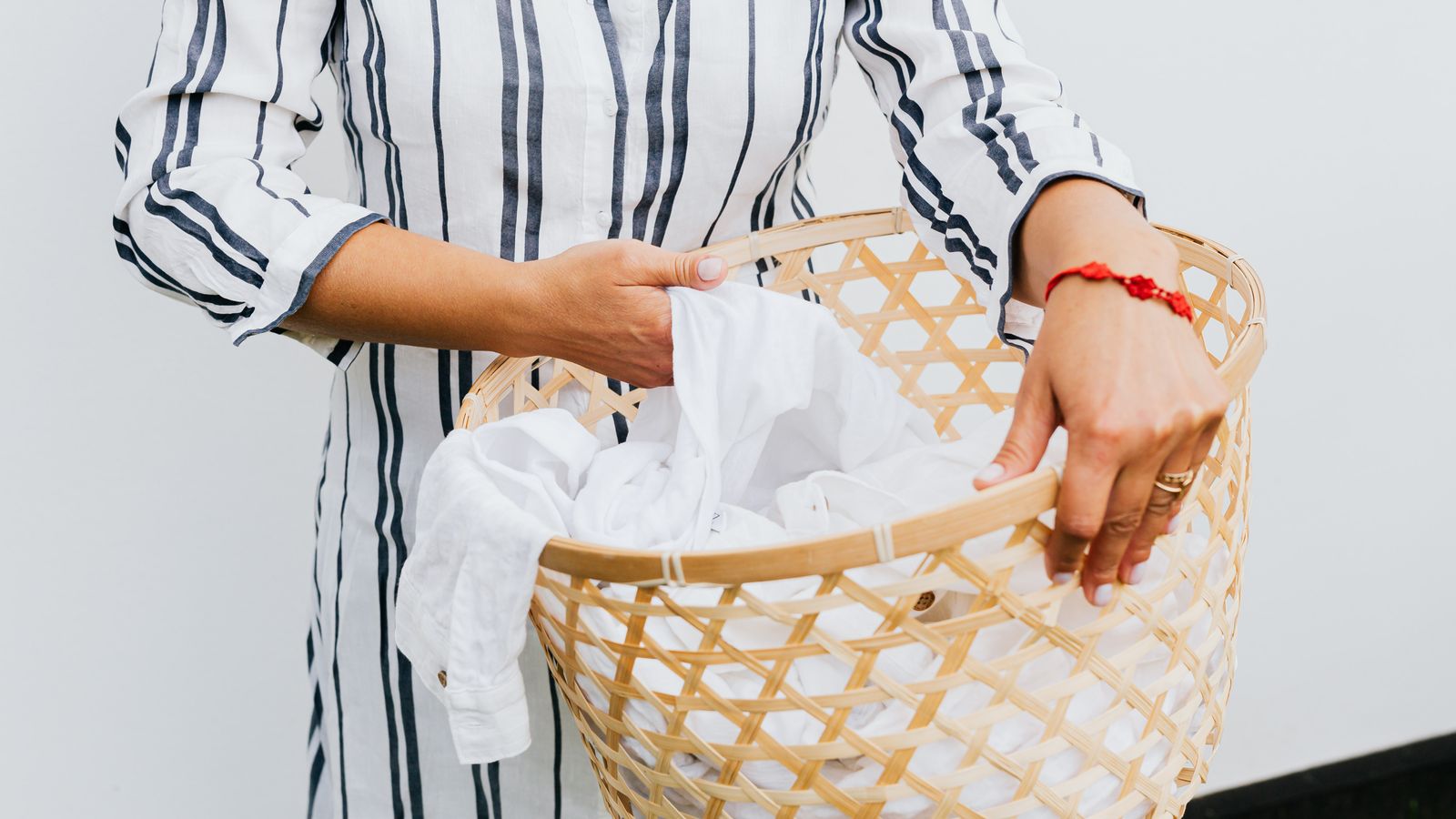 Folded laundry and a basket of clean clothes ready for a laundry care routine