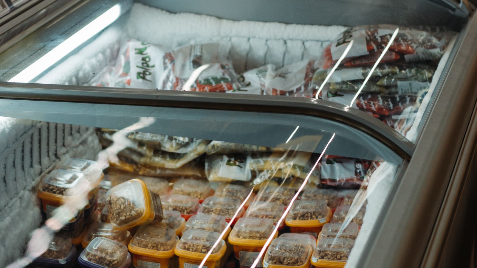 Neatly organized chest freezer with labeled frozen food containers