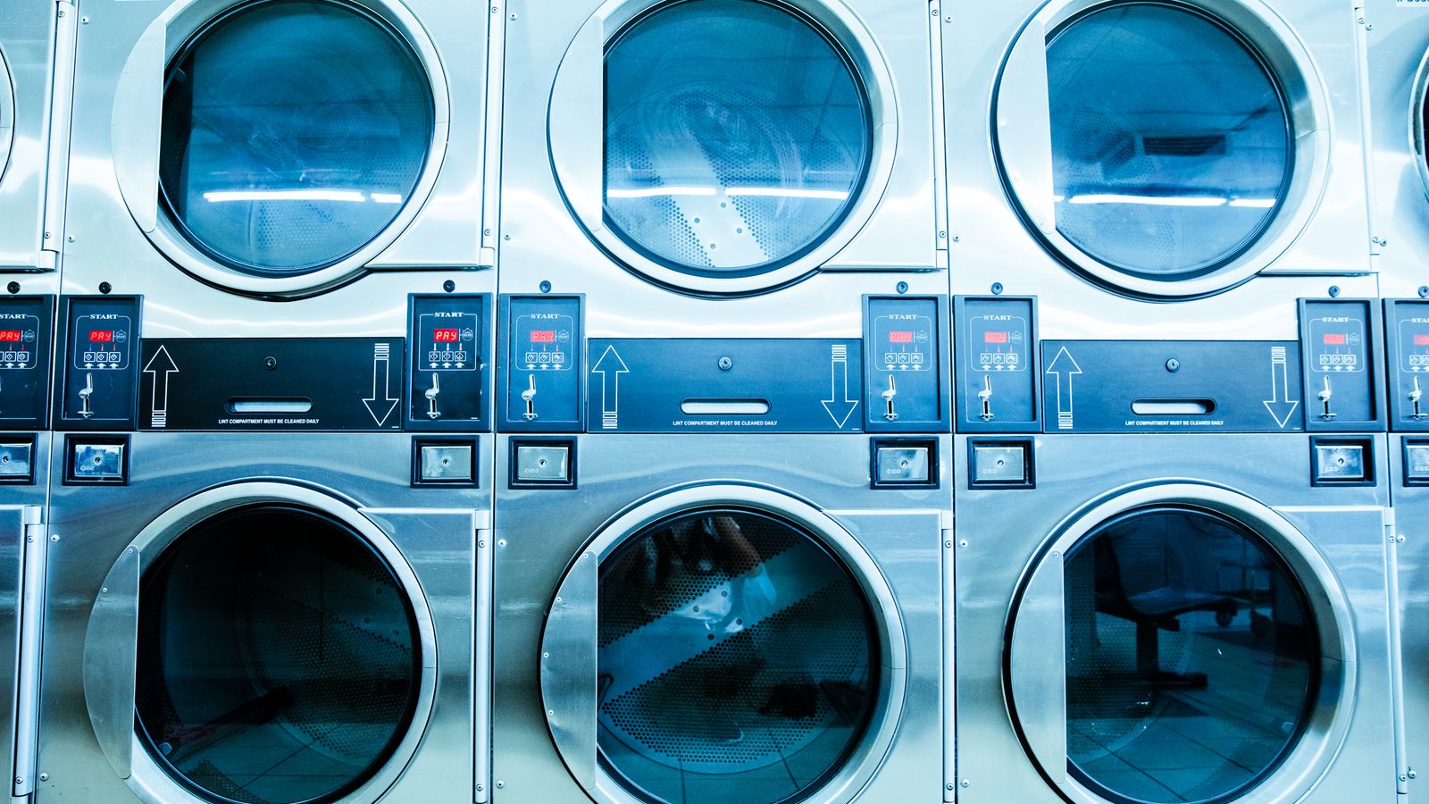 Close-up of a washing machine drain hose connection behind the unit