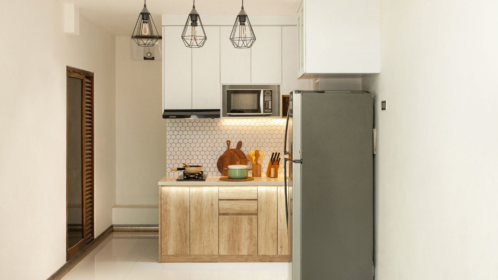 Person using an appliance dolly to move a large kitchen appliance