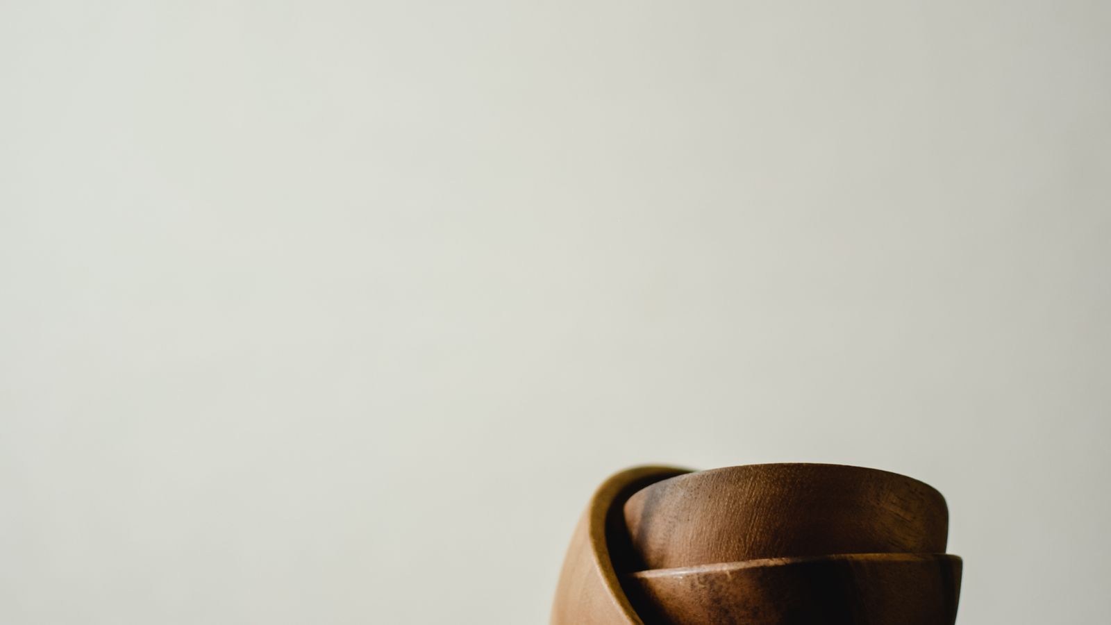 Close-up of hands gently wiping a glass decorative bowl with a soft cloth
