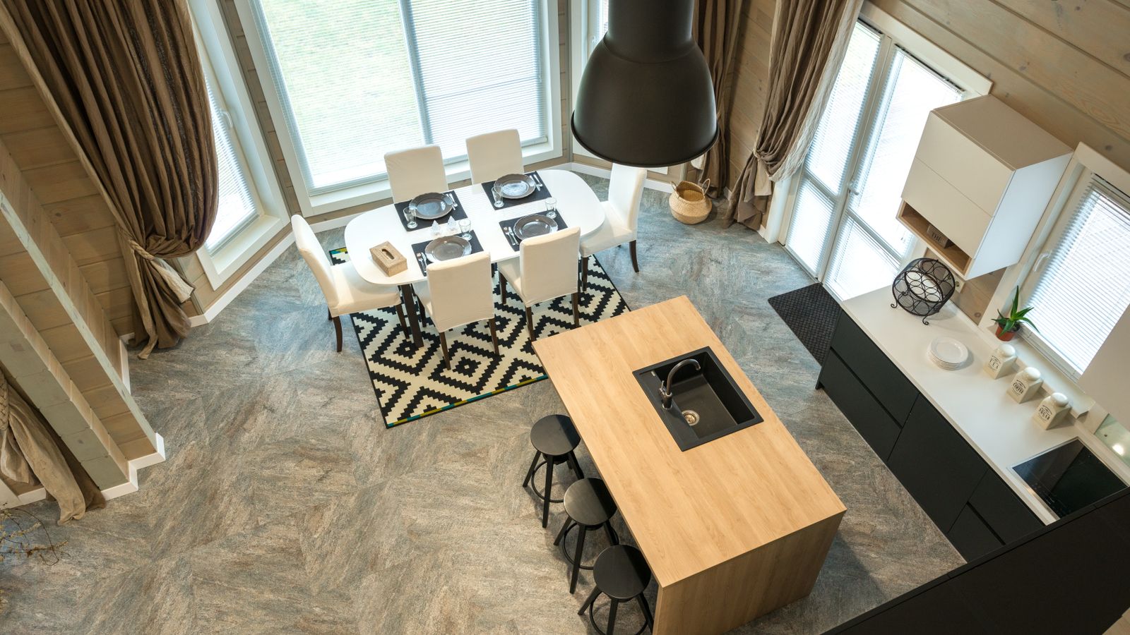 Dining table set on a rug in a stylish kitchen interior