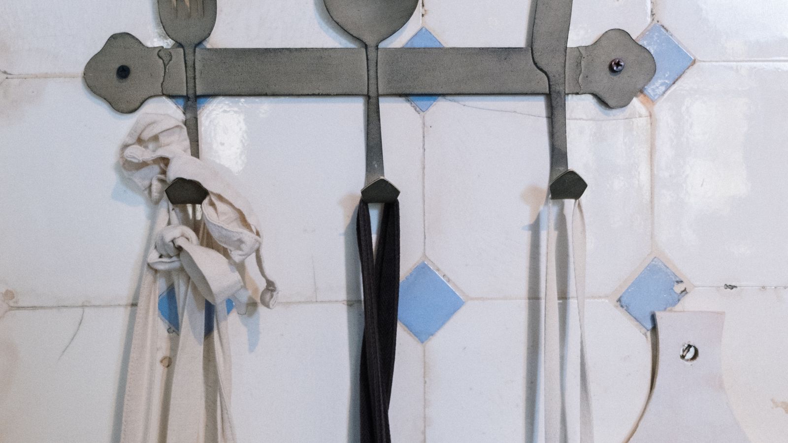 Stainless steel under cabinet knife rack mounted above a kitchen counter