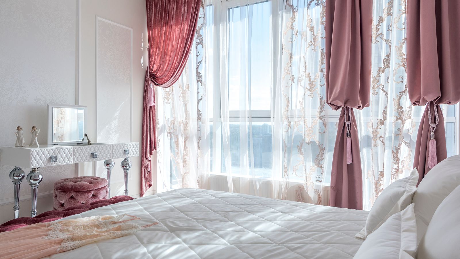 Bedroom window with layered curtain treatment showing coordinated fabric tones