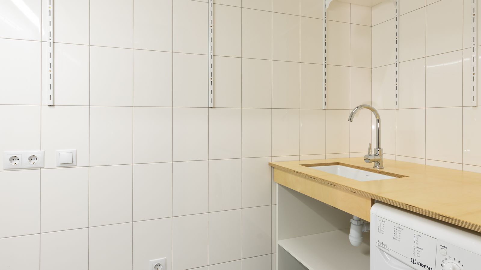 Close-up of laundry room cabinet with hardware and shelving used for storage