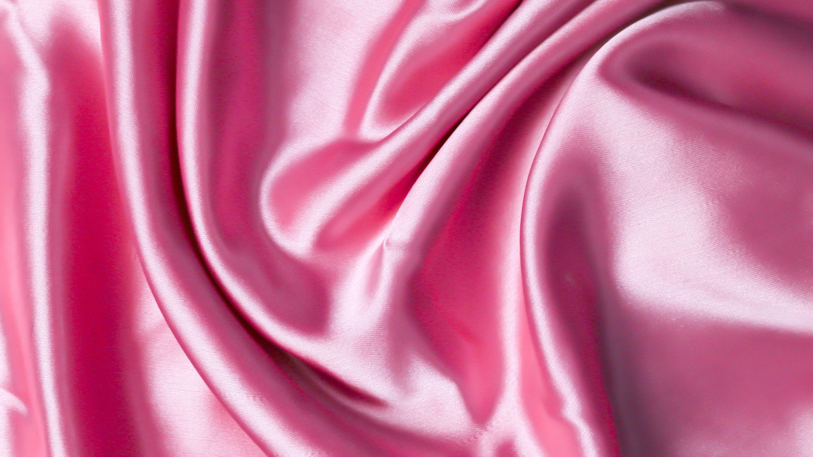Delicate silk fabric folded near a gentle laundry detergent bottle