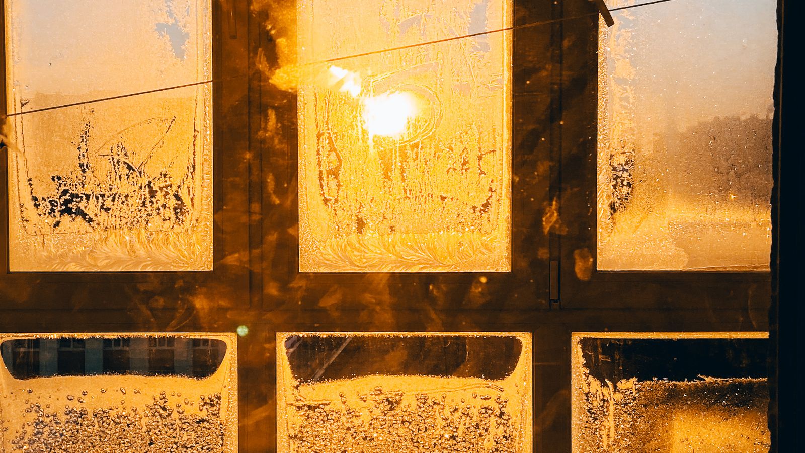 Close-up of subtle frosted film texture on a narrow apartment window
