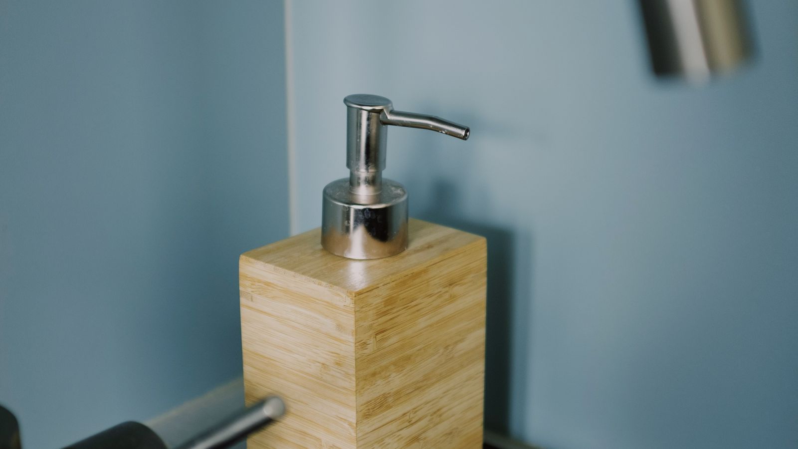 Compact under-sink hot water tank installed in a small kitchen cabinet