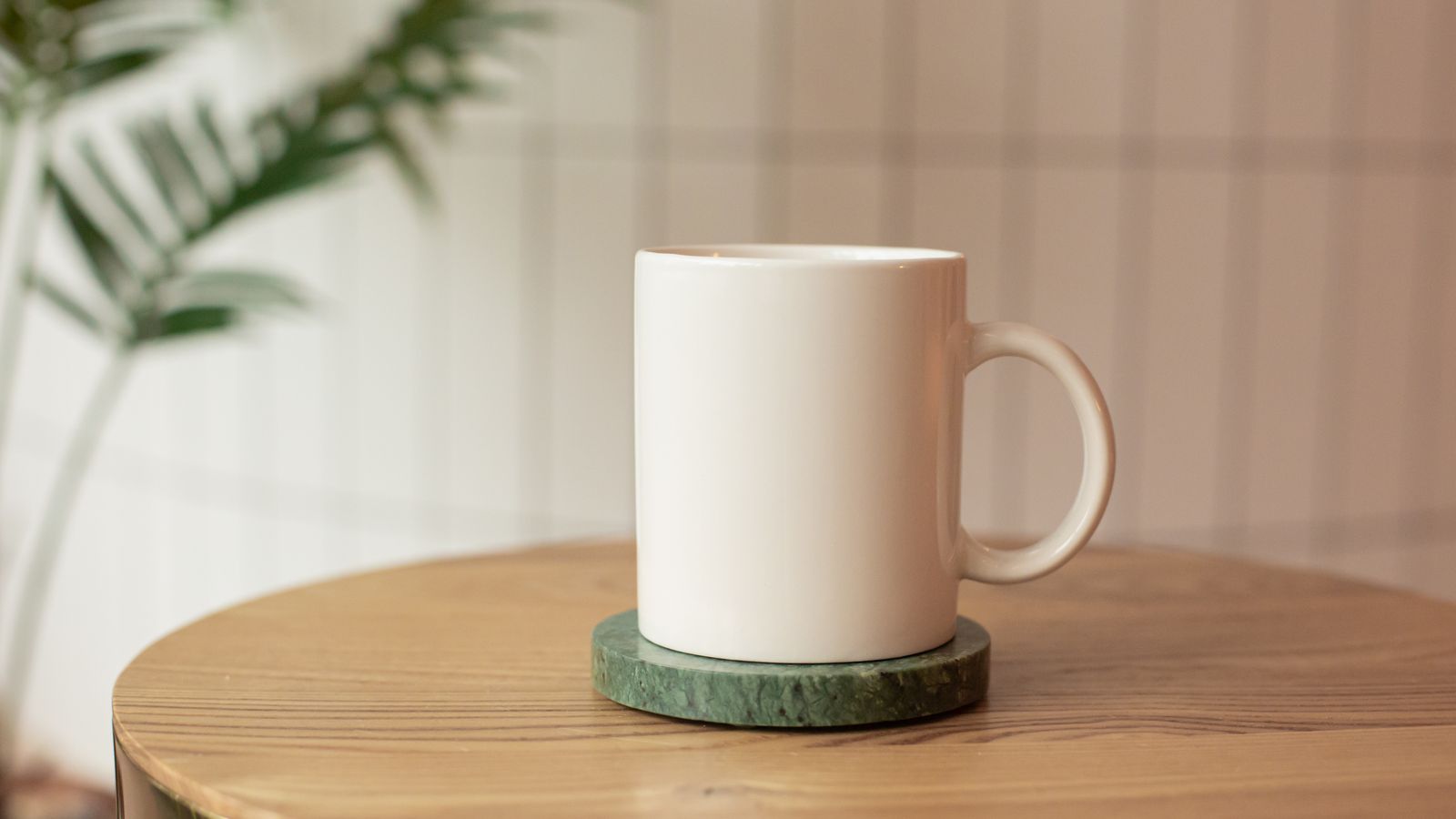 Set of coasters styled on a coffee table with drinkware