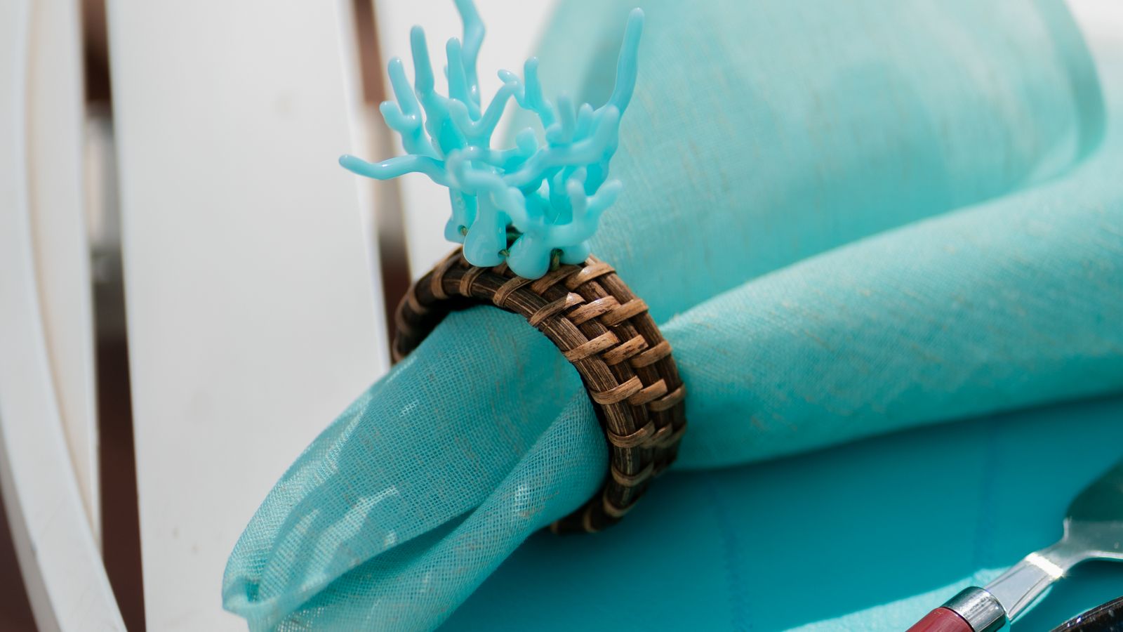 Table setting with decorative napkin rings on folded cloth napkins