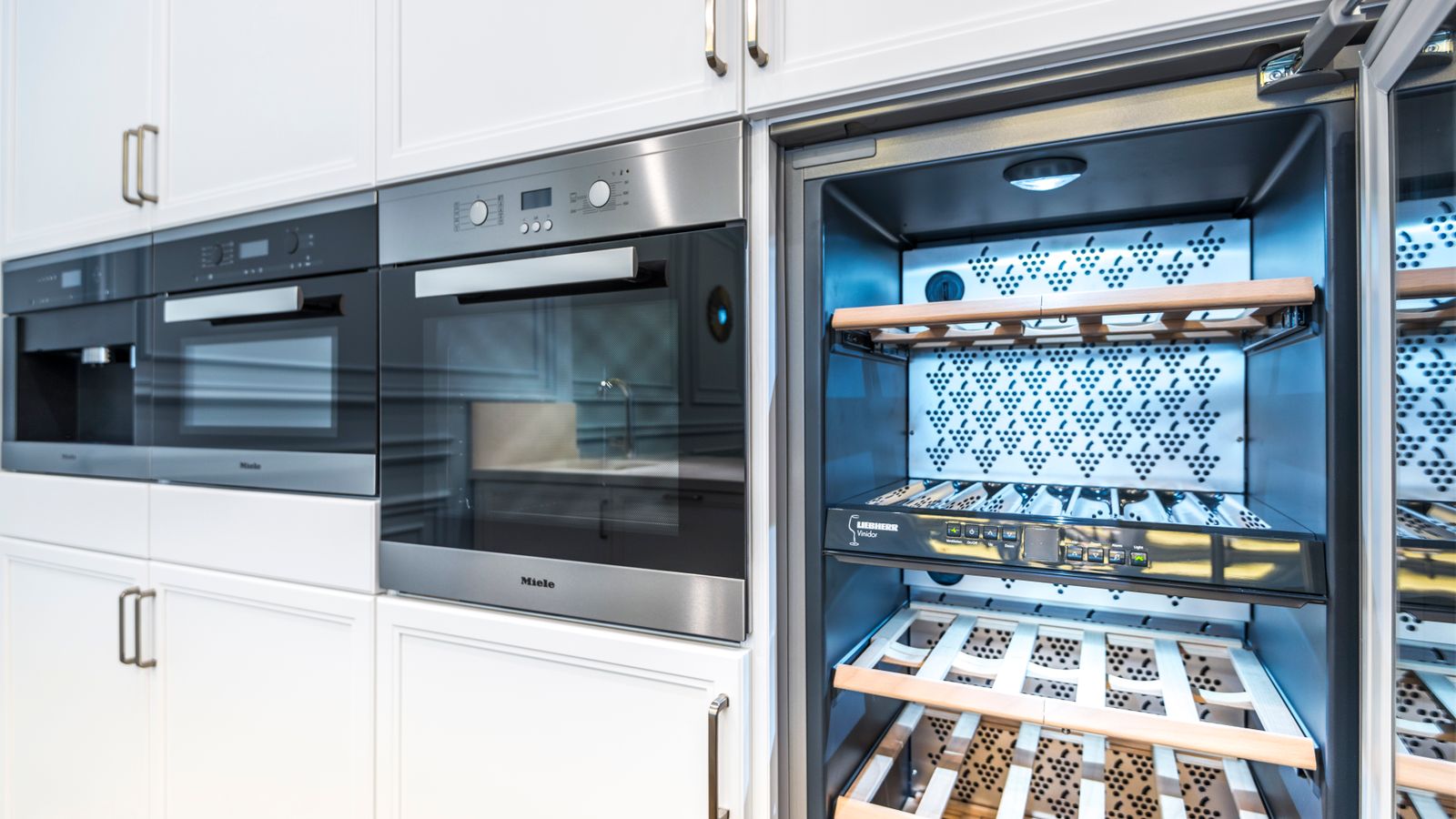 Modern renovated kitchen with built-in appliances and cabinetry ready for new fixtures