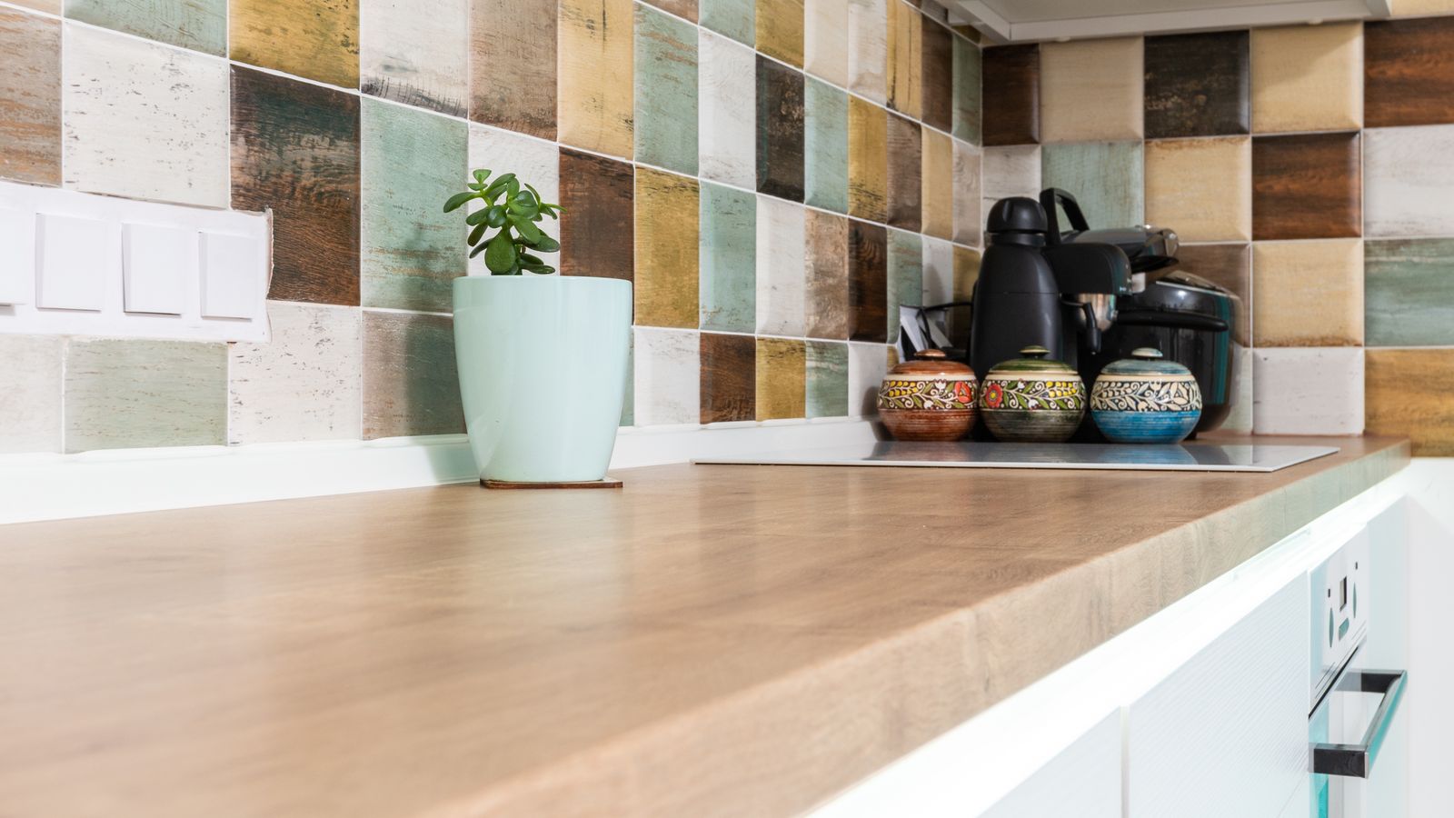 Kitchen wall with tile backsplash installation in progress during renovation
