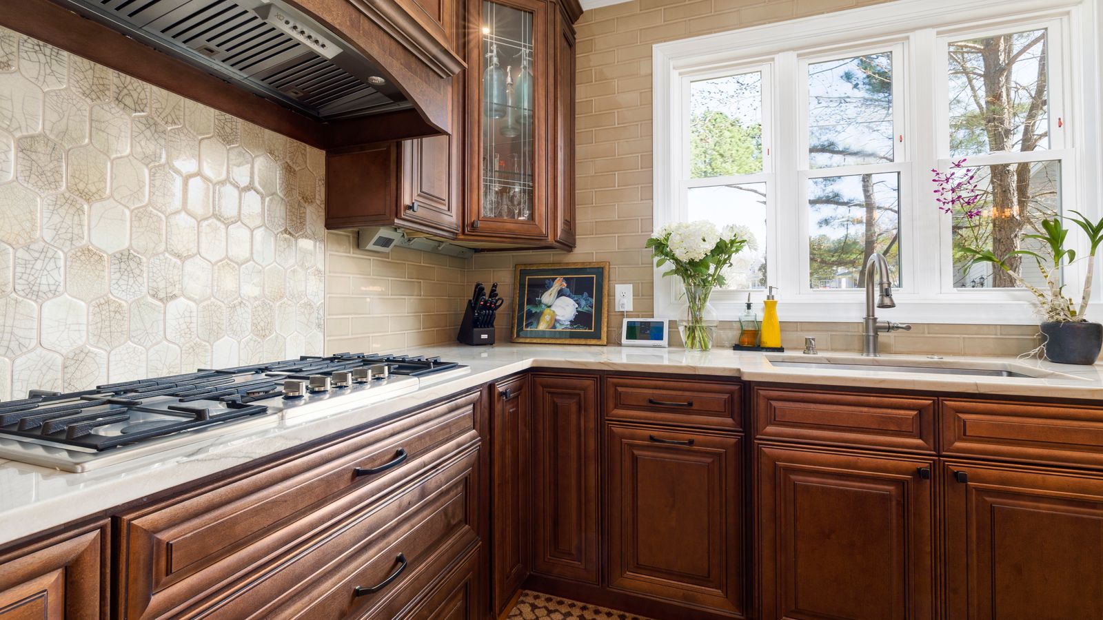 Close-up of undermount sink basin installed beneath a stone kitchen countertop