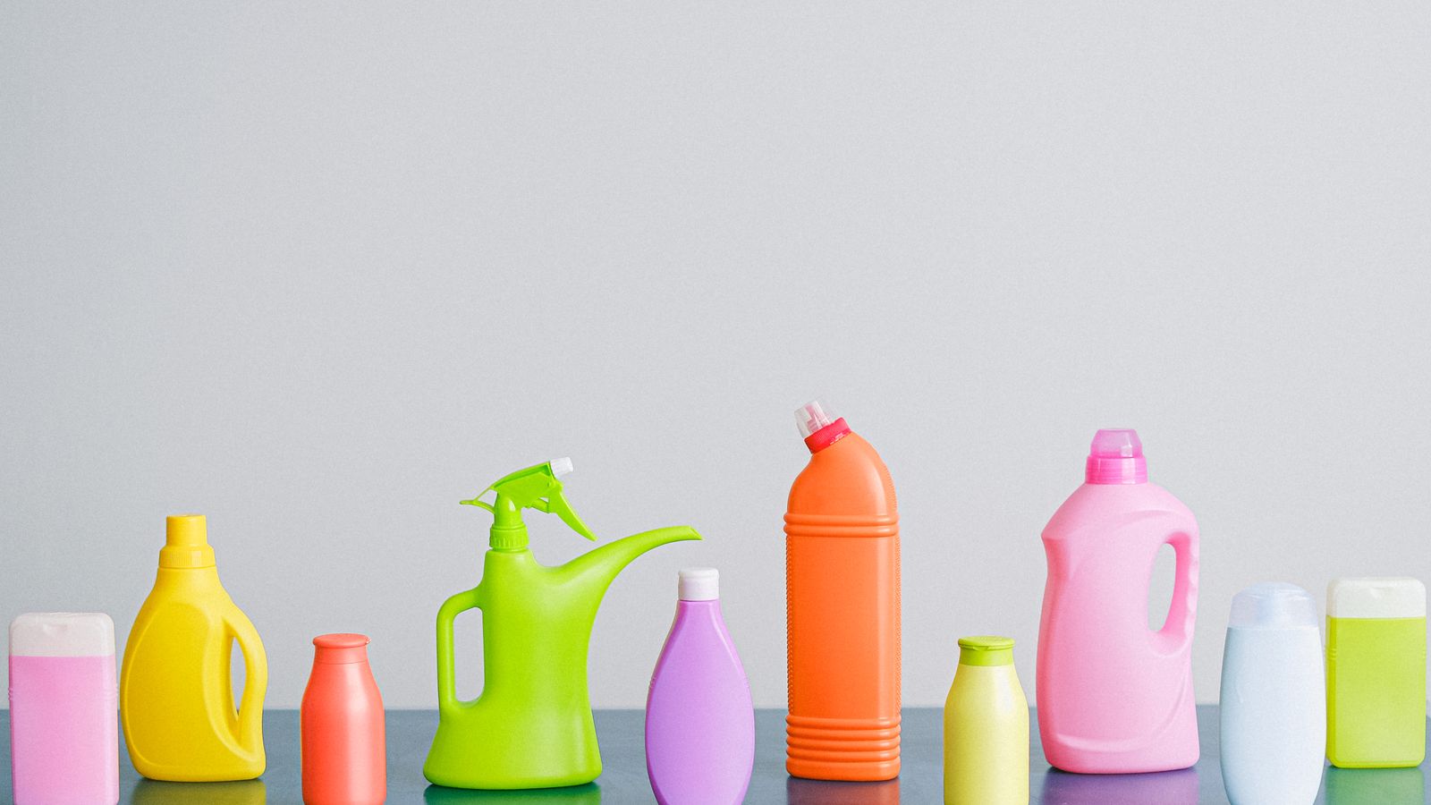 Assorted budget cleaning supply bottles organized on a shelf