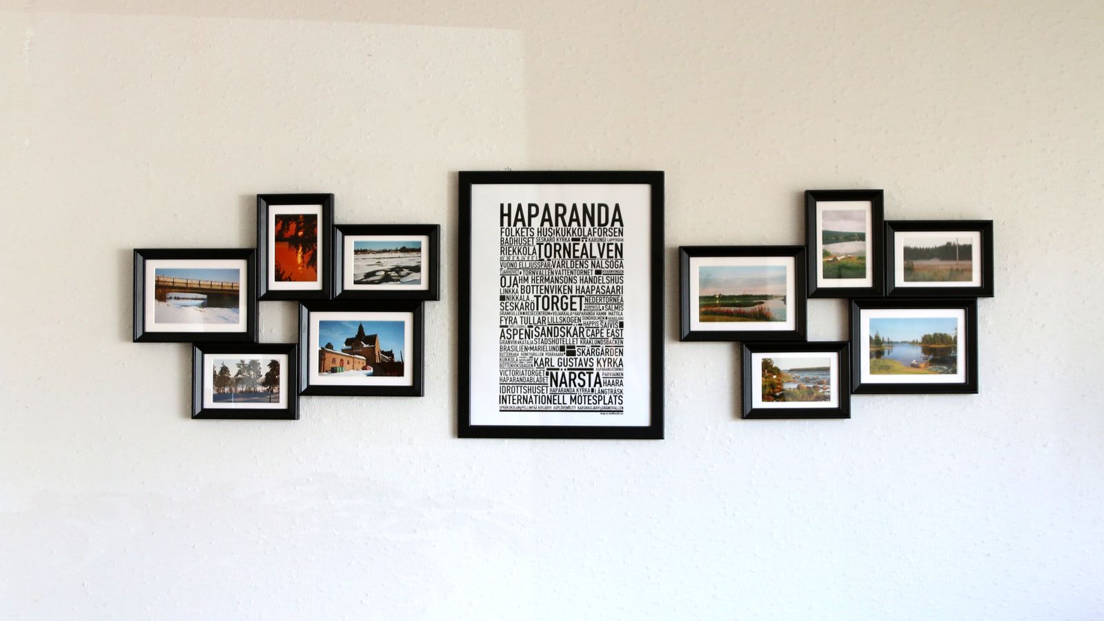Gallery wall with a photo collage frame arrangement above a console table