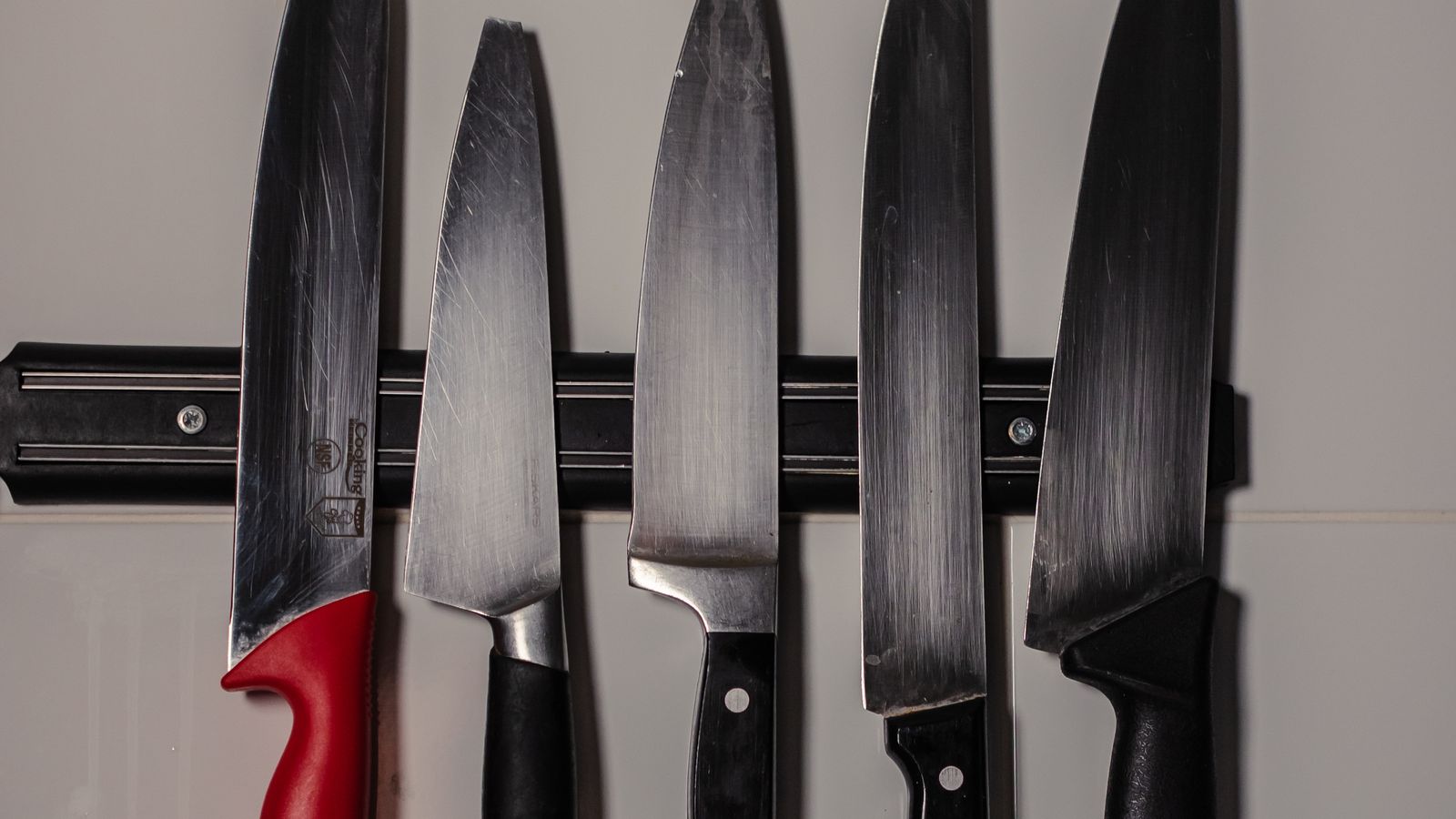 Kitchen knives stored safely on an under cabinet magnetic knife rack
