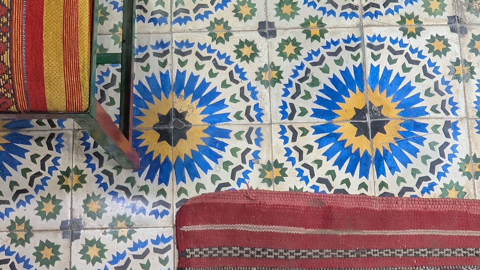 Patterned kitchen area rug on tile floor near a work zone