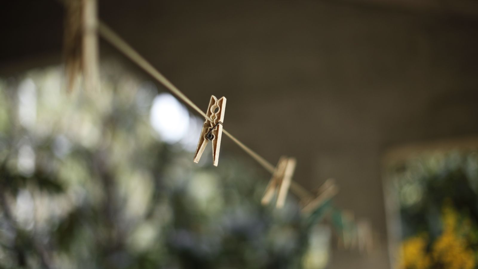 Person coiling and bundling a clothesline cord before storage