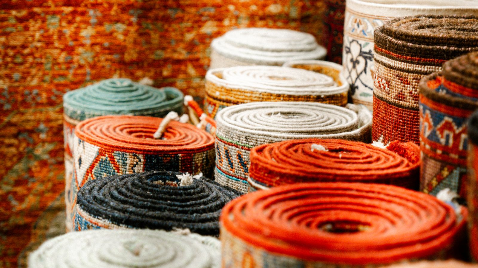 Rolled up laundry room rug ready for storage on a wooden floor