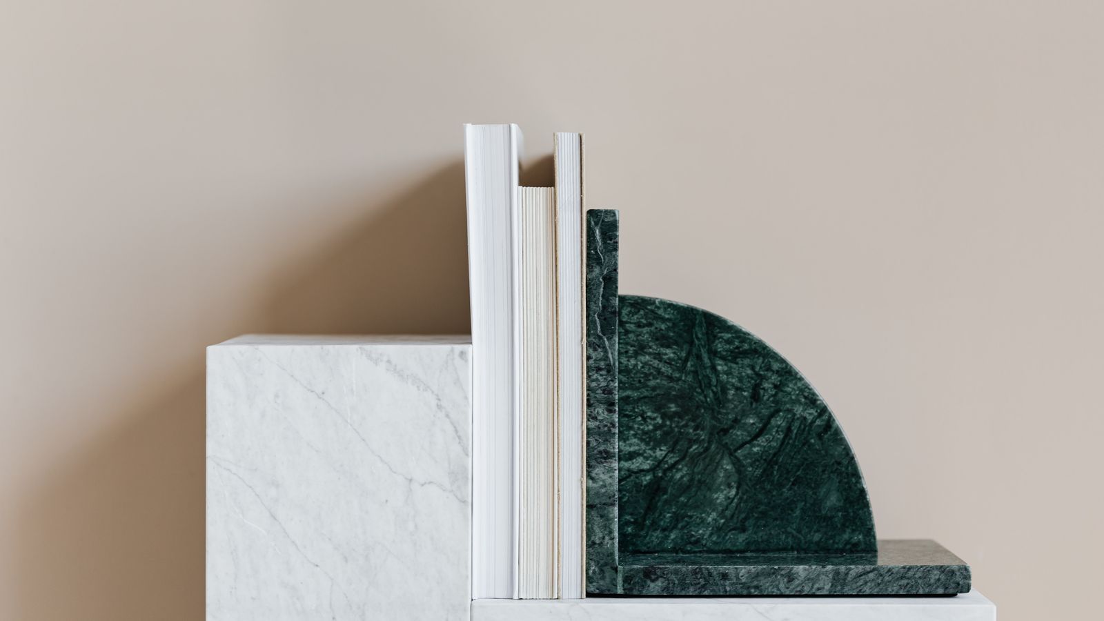 Close-up of a bookend base with felt pad protecting a wooden shelf