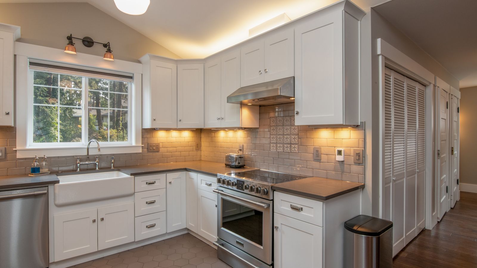 Farmhouse apron-front sink installed in a bright renovated kitchen
