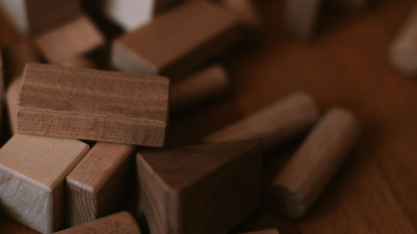 Small wooden cedar blocks arranged on a surface near stored clothing