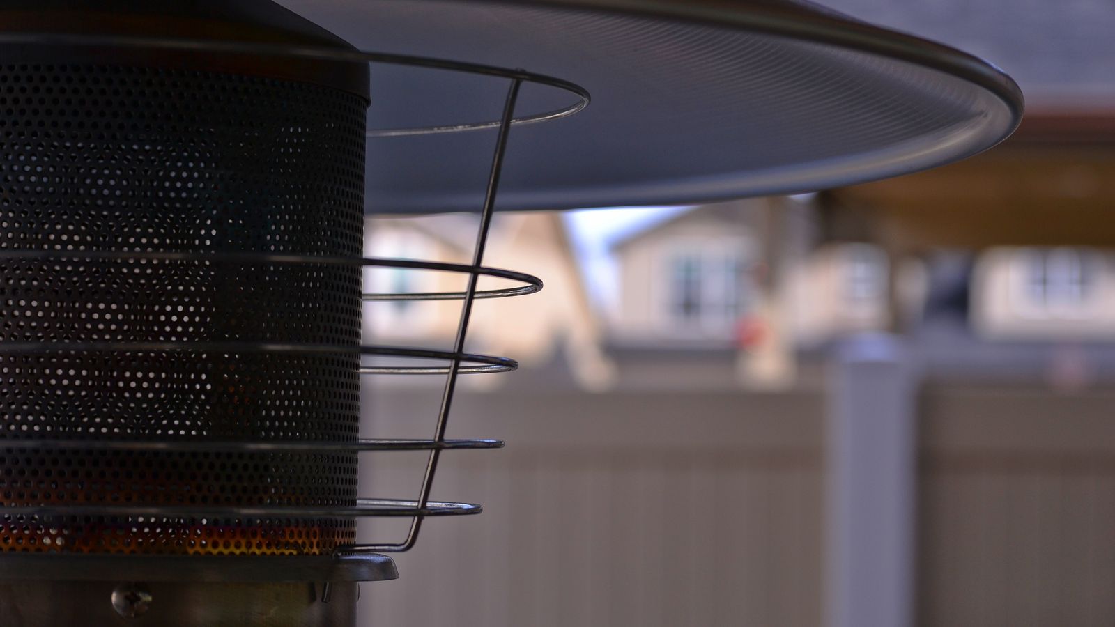 Compact space heater warming a small room corner near a chair