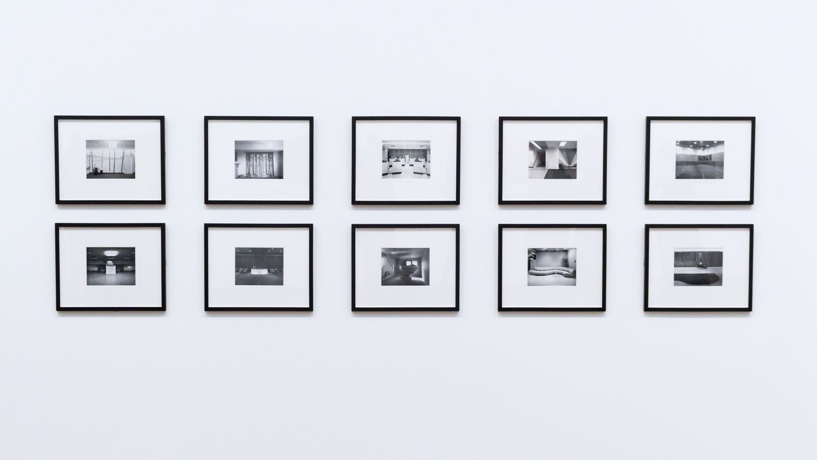 Framed prints arranged in a gallery wall layout above a minimalist console table