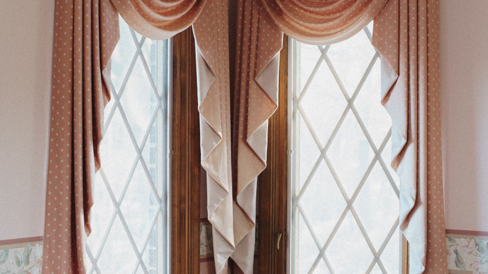 Close-up of a decorative fabric valance mounted above a bright window